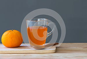 Orange with orange juice in glass