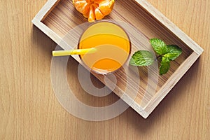Orange and orange juice with mint in tray wood on wooden background