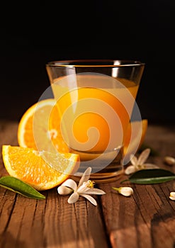 Orange, orange juice on rustic wood background