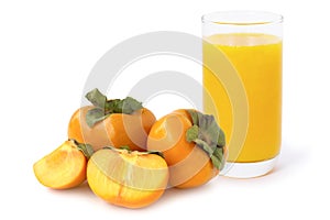 Orange organic ripe Fuyu Persimmons or Persimon fruits with glass of healthy persimmon smoothie .