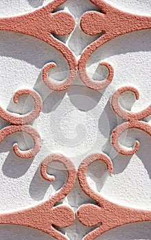 Orange oriental pattern with curls on white wall