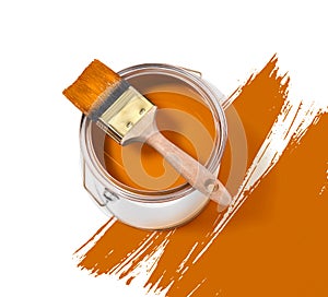 Orange paint tin can with brush on top on a white background with orange strokes