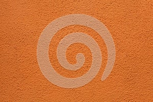 Orange painted stucco wall. Background texture