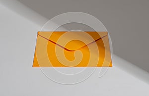 Orange paper envelope. Letter, mail, post, correspondence concept, sunlight