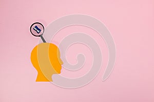 orange paper head with a cloud above, in it a sharpener, pink background and copy space