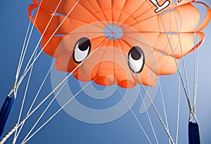 Orange parasail against blue sky photo