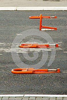 Orange parking barriers in the parking lot near the Russian store
