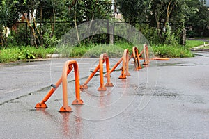 orange parking barriers, parking space limiters and blockers. Parking and road equipment