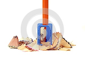 Orange pencil in a blue sharpener