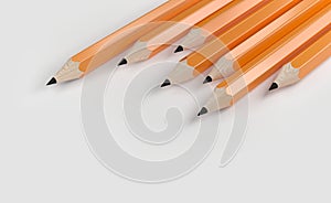Orange pencils isolated on grey background.