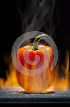 Orange Pepper on a Hot Flaming Barbecue Grill