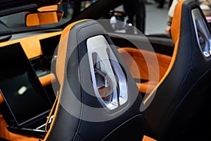 Orange perforated leather. Details inside a modern car