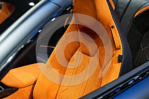 Orange perforated leather. Details inside a modern car