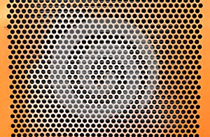 Perforated metal grid many holes orange construction texture background