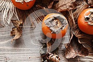 Orange persimmons on wooden table