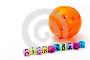 Orange Pickleball with block letters PICKLEBALL
