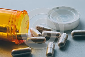 Orange pill bottle and medicine pills or tablets, medications pharmacy drugs concept, macro close up