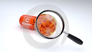 Orange pill or capsule is under magnifying glass filled with vitamin C.