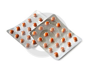 Orange pills in blister packs isolated on white background