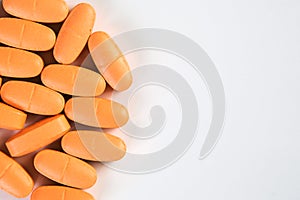 Orange pills, prescription drugs on white background