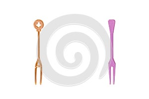 Orange and pink plastic forks isolated on white background