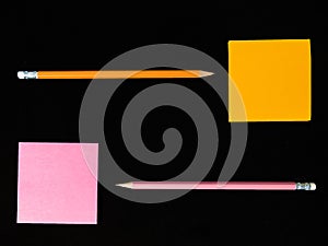 Orange and pink post note or post it with black head pencil in o