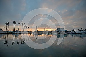 Orange and pink sunrise sky over Channel Islands harbor in Port Hueneme on the gold coast of California USA