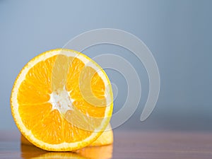 Orange placed on a wooden table.