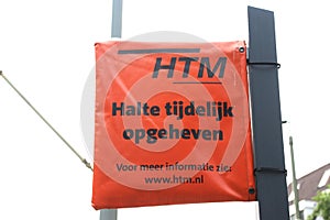 Orange plastic bag around tram stop sign due to temporary closing of the stop by HTM in The Hague.