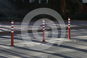 Orange plastic bollard on the road