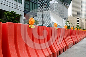 Orange plastic Jersey Barriers protect a construction site