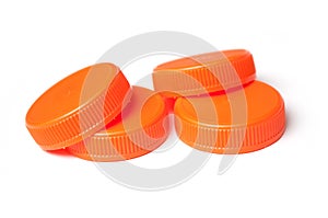 orange plastic plugs for recycling on white background