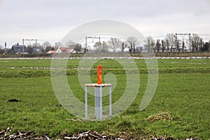 Orange pole in a meadow for the defence pipeline organization DPO