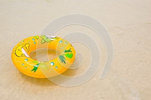 Orange pool float, pool ring on the beach