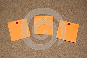 Orange Post it Notes on a Cork Board