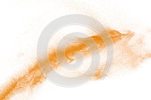 Orange powder dust particles explosion on white  background.Orange dust particles splash