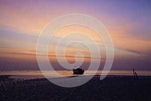 Orange predawn skies and a stranded lone boat