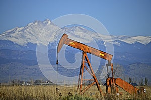 Orange Pump Jack Oil Well and Longs Peak photo