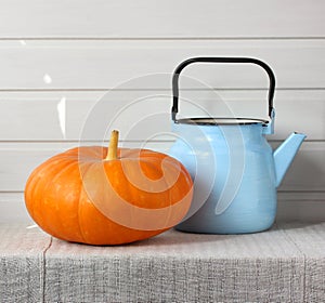 Orange pumpkin and blue teapot