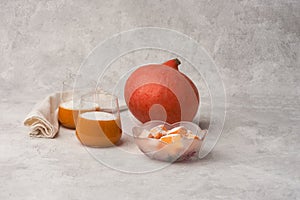 Orange pumpkin and jelly pumpkin desserts on gray textured background. Copy space.