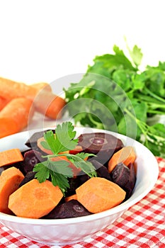 Orange and purple carrots with green parsley