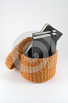 Orange rattan basket with notebooks
