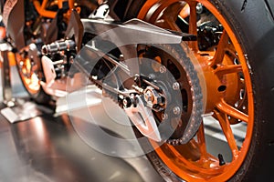 Orange Rear wheel of a racing motorcycle