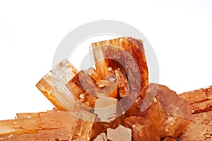 Orange red aragonite crystal on white background