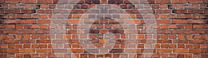 Orange red brown damaged rustic brick wall brickwork stonework masonry texture background banner panorama pattern template