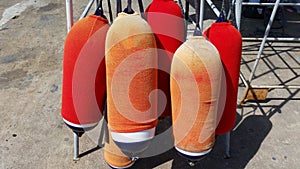Orange and red fenders for boat