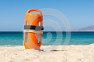 Orange rescue buoy on the beach