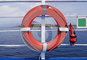 Orange rescue buoy or life ring on the deck of a ferry sailing to Corfu island, Greece. Safety equipment on the ship