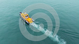 Orange rescue or coast guard patrol boat, patrolling. Police motor boat