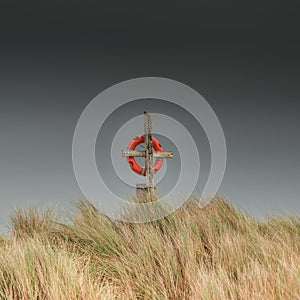 Orange rescue lifebuoy with overcast sky